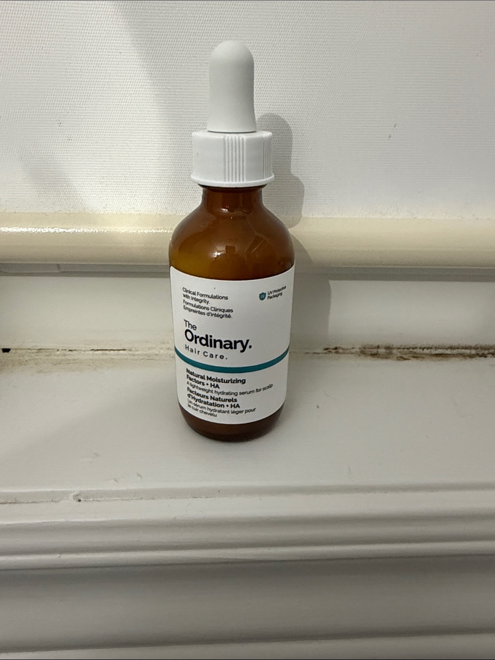 The Ordinary Amber Bottle with White Dropper and Teal Accent